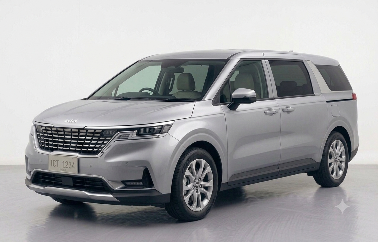 Front three-quarter view of a Snow White Pearl Kia Grand Carnival showcasing its modern, SUV-inspired design.