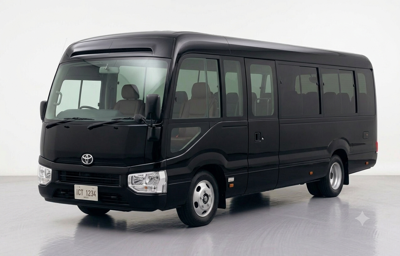 Front three-quarter view of a sleek, black Toyota Coaster luxury transport bus.